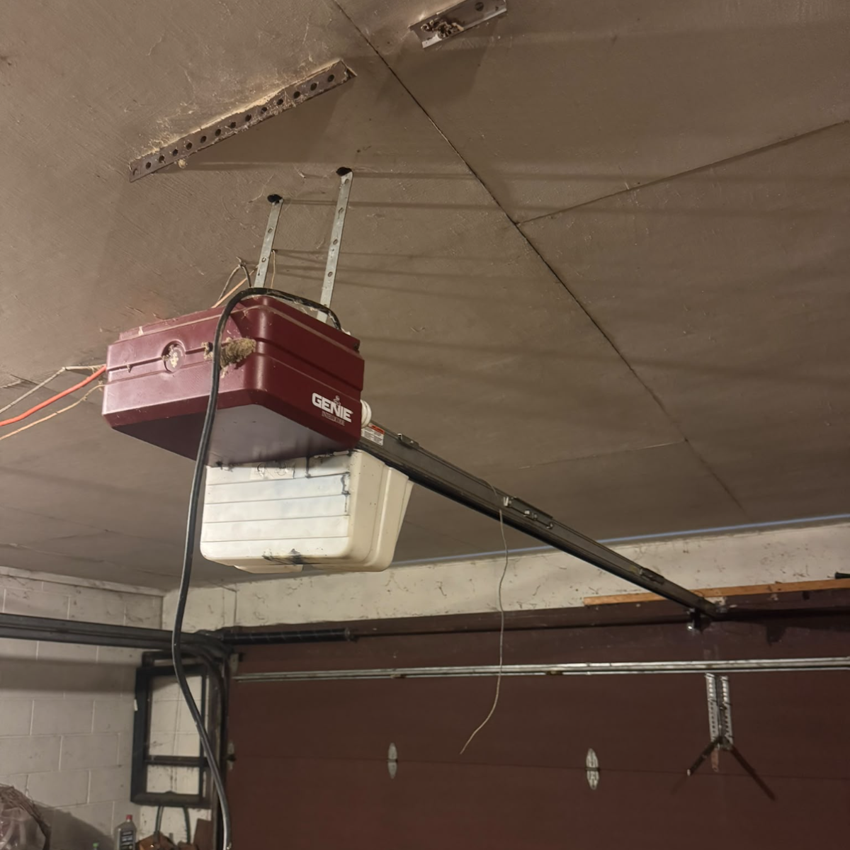 Old worn-out garage door opener before replacement